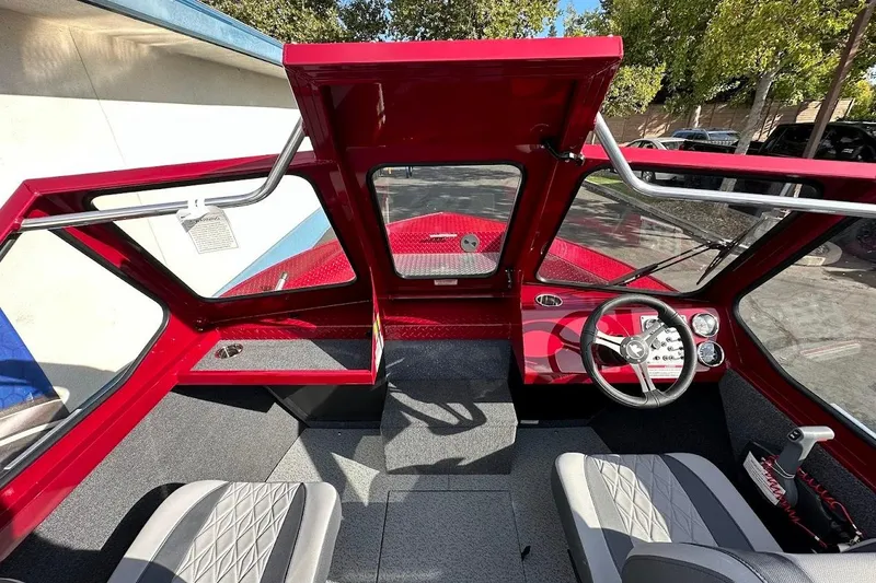 Slide: The Image of Interior of 2025 Duckworth 20 Advantage SE boat with red dashboard and gray seating. - 19