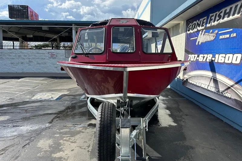 Slide: The Image of Red 2025 Duckworth 20 Advantage SE boat on trailer, parked outside a marine shop. - 2
