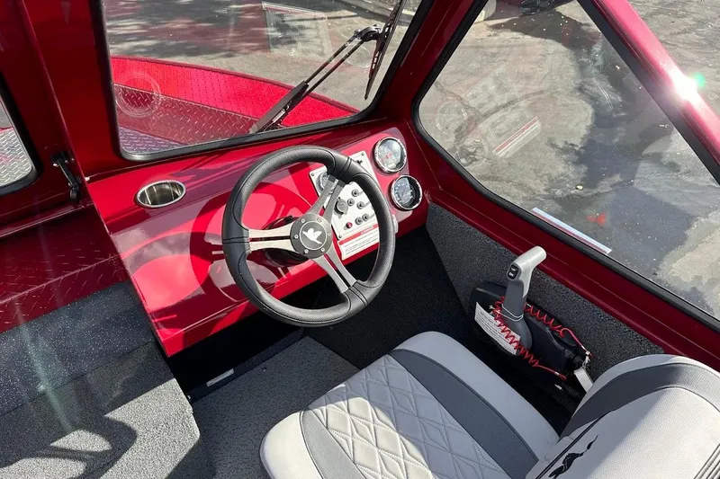 Slide: The Image of Interior of 2025 Duckworth 20 Advantage SE boat with red dashboard and steering wheel. - 21