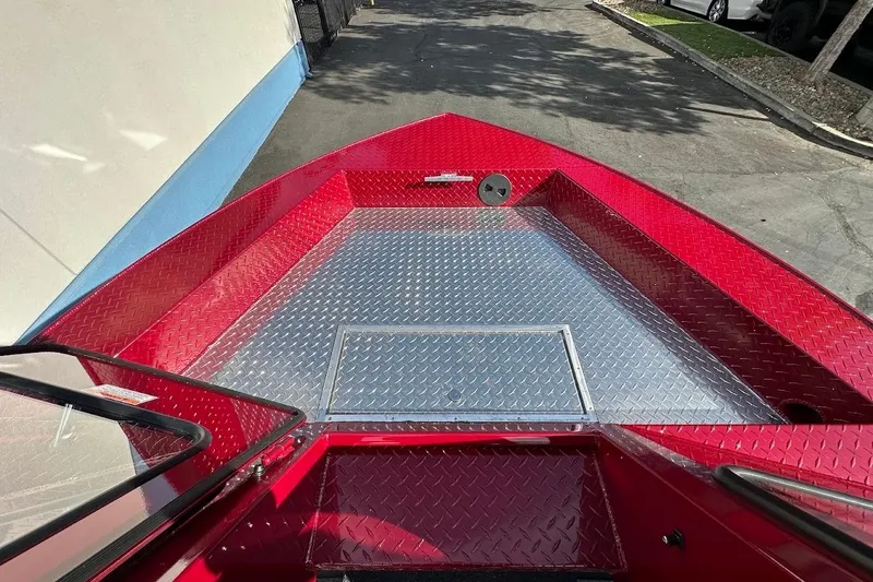 Slide: The Image of Red 2025 Duckworth 20 Advantage SE boat with diamond plate flooring, parked outdoors. - 24
