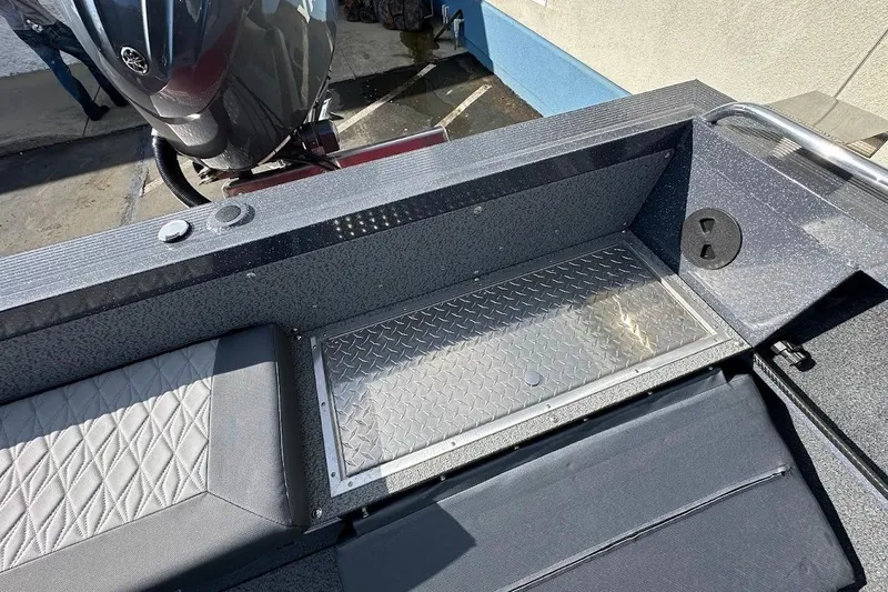 Slide: The Image of 2025 Duckworth 20 Advantage SE boat interior with diamond plate flooring and Yamaha outboard motor. - 26
