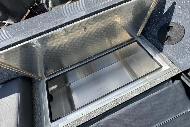 Slide: The Image of Open storage compartment in 2025 Duckworth 20 Advantage SE boat, featuring diamond plate lid. - 27