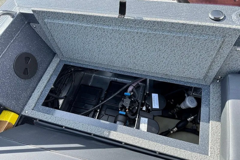 Slide: The Image of Open storage compartment in 2025 Duckworth 20 Advantage SE boat, showing internal components. - 29