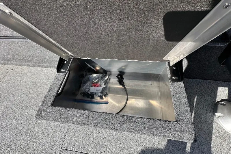 Slide: The Image of Storage compartment in 2025 Duckworth 20 Advantage SE boat, featuring carpeted interior and accessories. - 30
