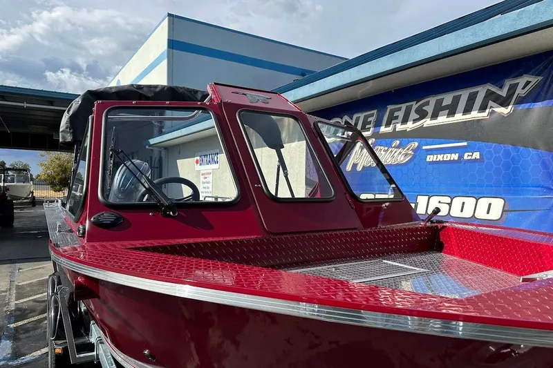 Slide: The Image of 2025 Duckworth 20 Advantage SE boat in vibrant red, parked outside a marine shop. - 6