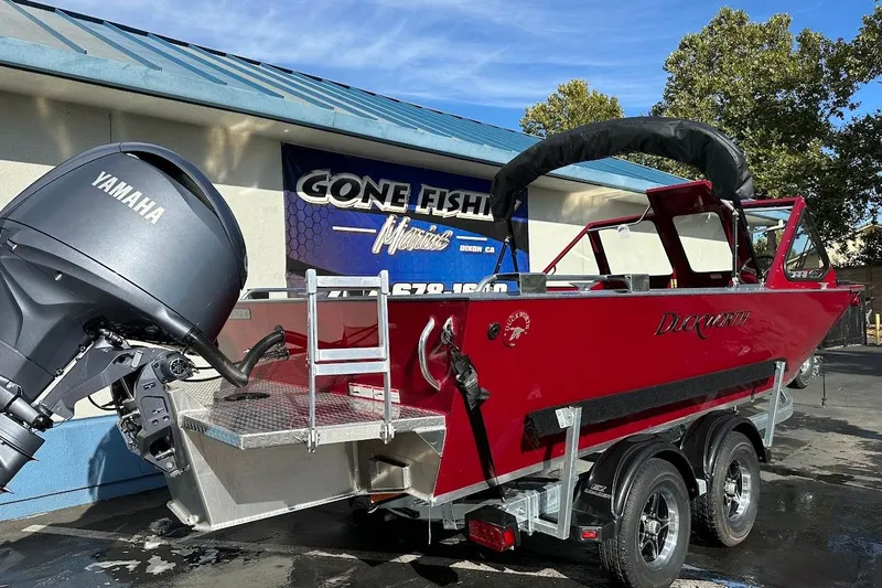 Slide: The Image of 2025 Duckworth 20 Advantage SE boat with Yamaha motor, parked outside a marine shop. - 8