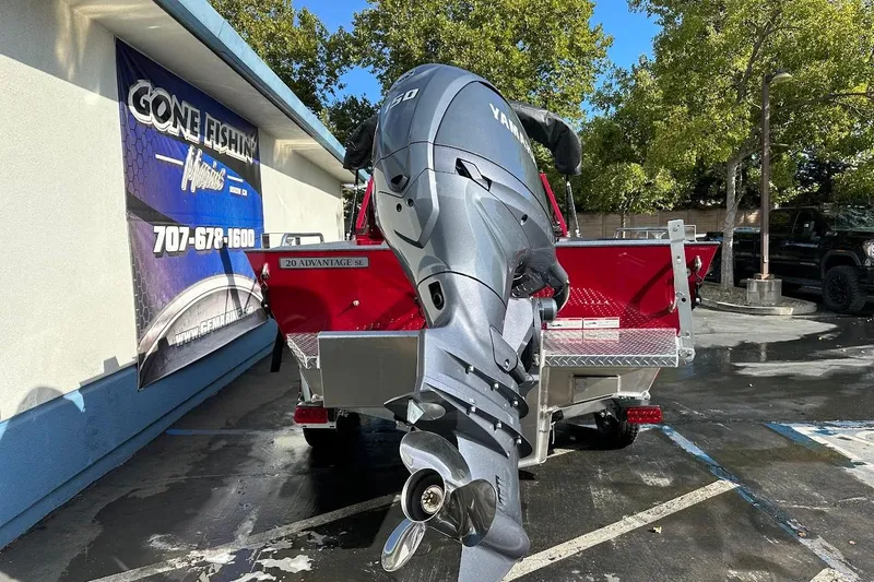 Slide: The Image of 2025 Duckworth 20 Advantage SE boat with Yamaha outboard motor, parked near a fishing store. - 9