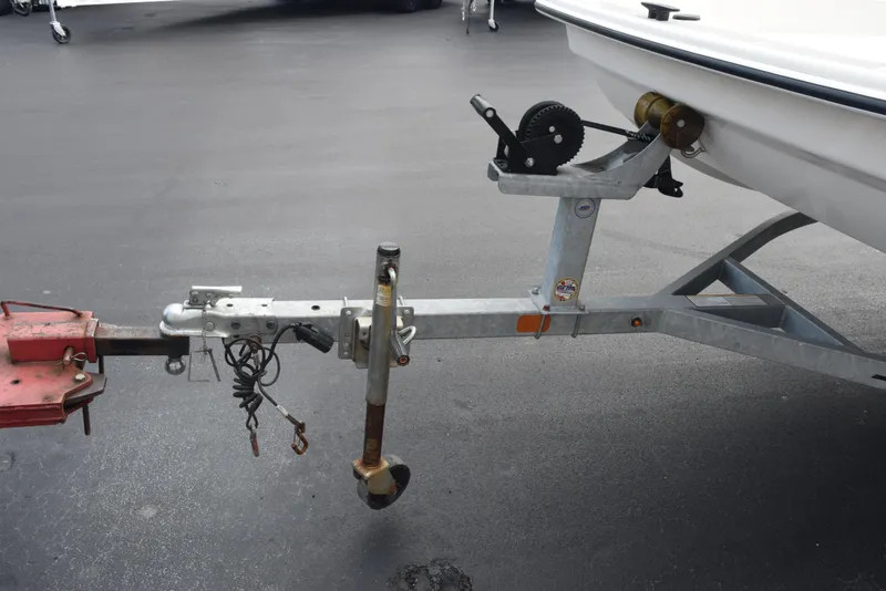 Slide: The Image of Trailer hitch of a 2022 Mako Pro Skiff 17 CC boat on pavement. - 10