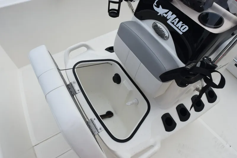 Slide: The Image of 2022 Mako Pro Skiff 17 CC boat interior with open storage compartment and seating. - 18