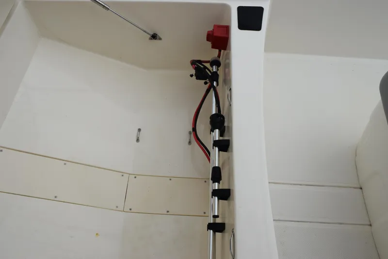 Slide: The Image of 2022 Mako Pro Skiff 17 CC interior with wiring and storage compartment. - 20