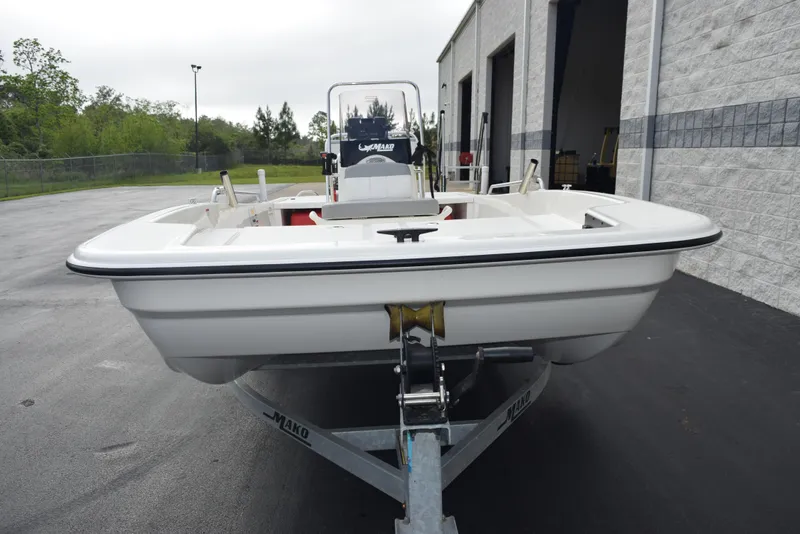 Slide: The Image of 2022 Mako Pro Skiff 17 CC boat on trailer, parked outside a building. - 3