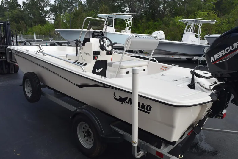 Slide: The Image of 2022 Mako Pro Skiff 17 CC boat on trailer, featuring a Mercury outboard motor. - 6