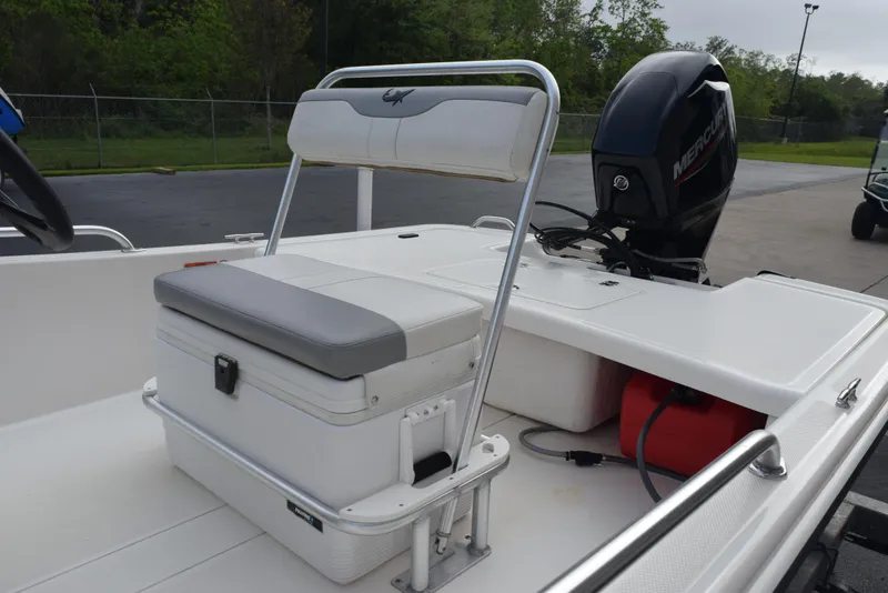 Slide: The Image of 2022 Mako Pro Skiff 17 CC boat interior with seating and Mercury outboard motor. - 8
