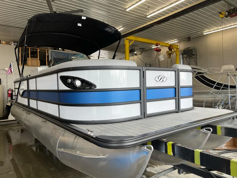 The Image of 2025 Bentley Pontoons Legacy 243 Navigator in a garage, featuring dual captain seats and full tube extension. - 0