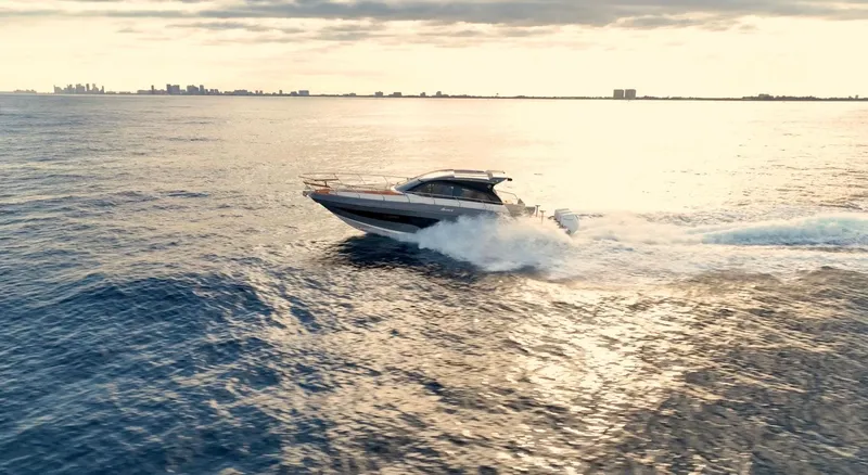 Slide: The Image of 2024 Hanover 415 yacht cruising on open water at sunset. - 1