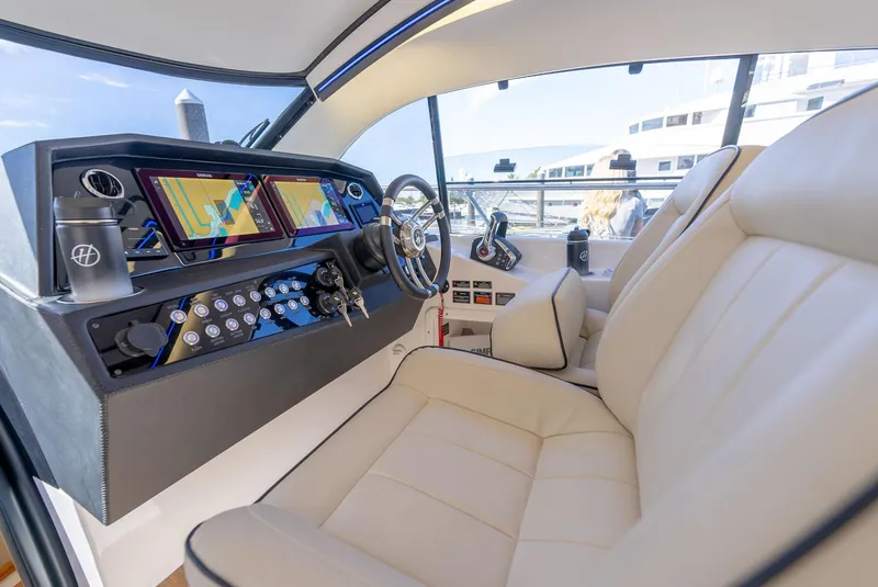 Slide: The Image of 2024 Hanover 415 yacht cockpit with modern controls and luxurious seating. - 16