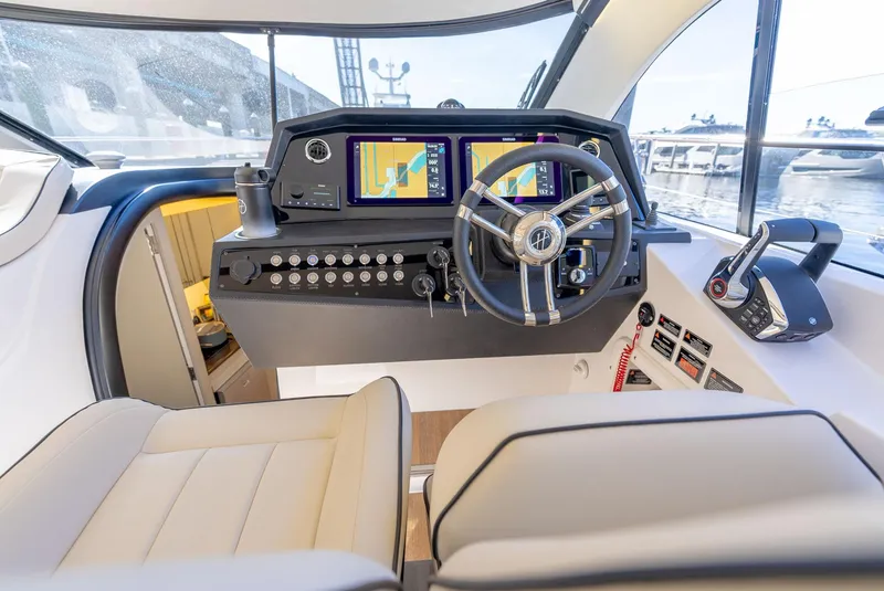 Slide: The Image of 2024 Hanover 415 yacht cockpit with modern navigation system and luxurious seating. - 17