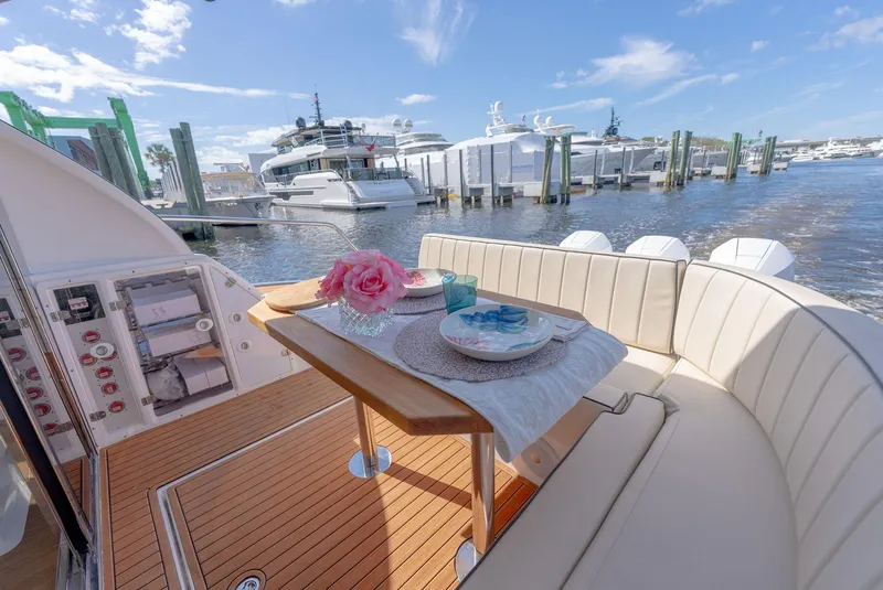 Slide: The Image of Luxurious 2024 Hanover 415 yacht interior with elegant dining setup, docked at a marina. - 19
