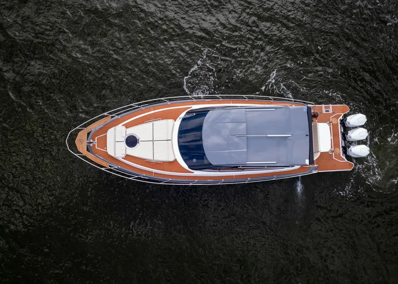 Slide: The Image of Aerial view of 2024 Hanover 415 luxury yacht cruising on water. - 2