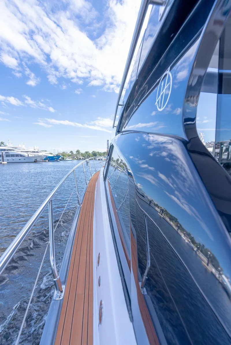 Slide: The Image of 2024 Hanover 415 yacht reflecting sky and water, showcasing sleek design and craftsmanship. - 20