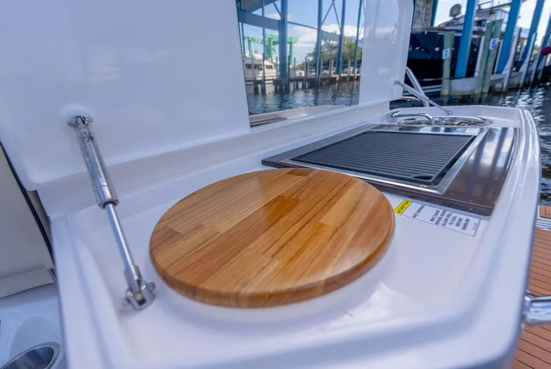 Slide: The Image of Outdoor kitchen on 2024 Hanover 415 yacht with cutting board and grill. - 21