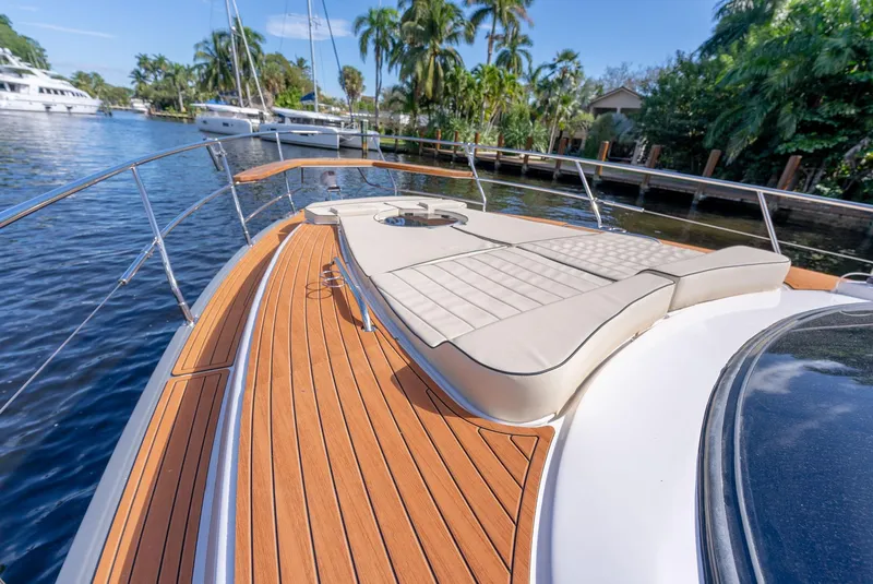 Slide: The Image of Luxurious 2024 Hanover 415 yacht with teak deck and sunbed, docked by palm trees. - 24