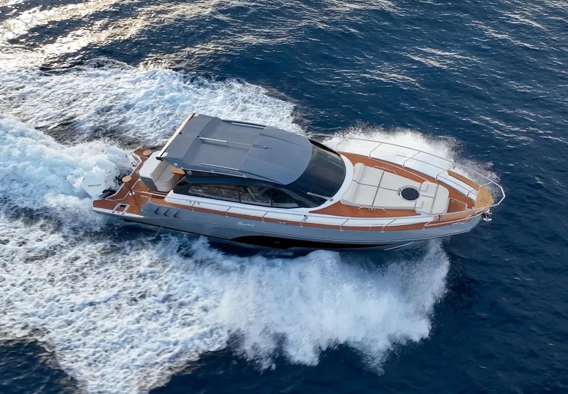 Slide: The Image of Luxurious 2024 Hanover 415 yacht cruising swiftly on open blue waters. - 26