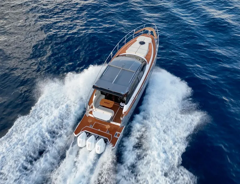 Slide: The Image of 2024 Hanover 415 boat cruising on open water, aerial view. - 28