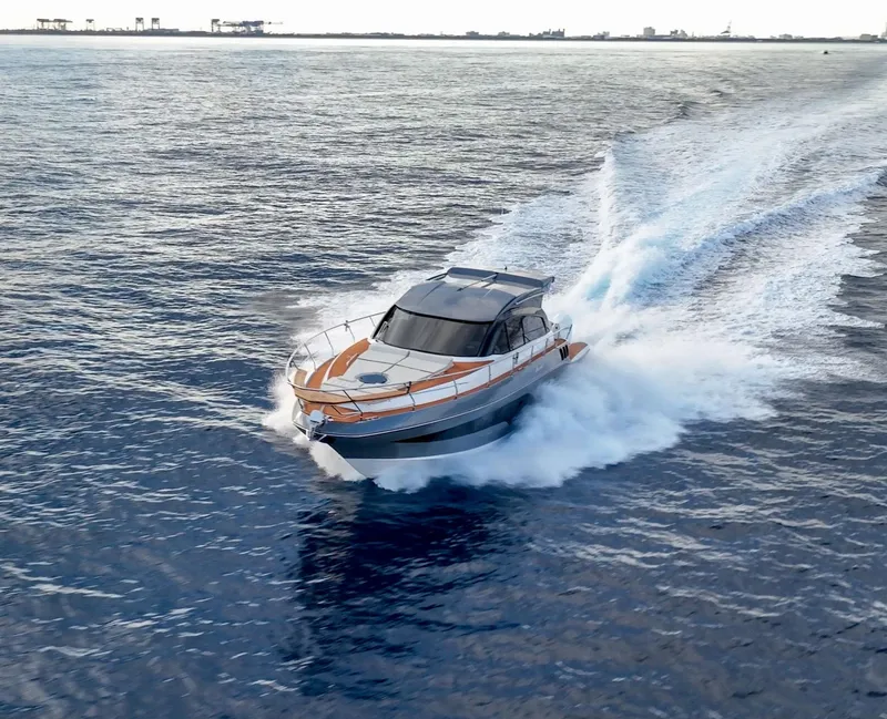 Slide: The Image of 2024 Hanover 415 yacht cruising swiftly on open water. - 31