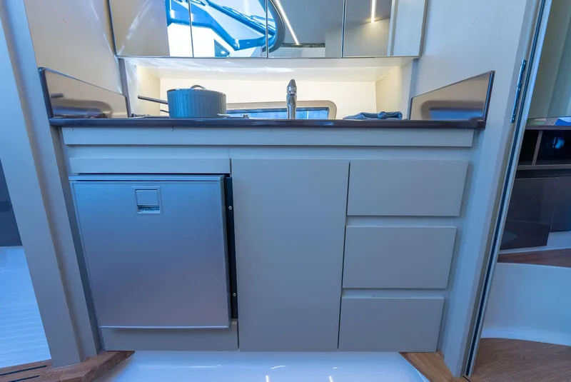 Slide: The Image of Modern kitchen area in a 2024 Hanover 415 yacht, featuring sleek cabinetry and stainless steel appliances. - 8