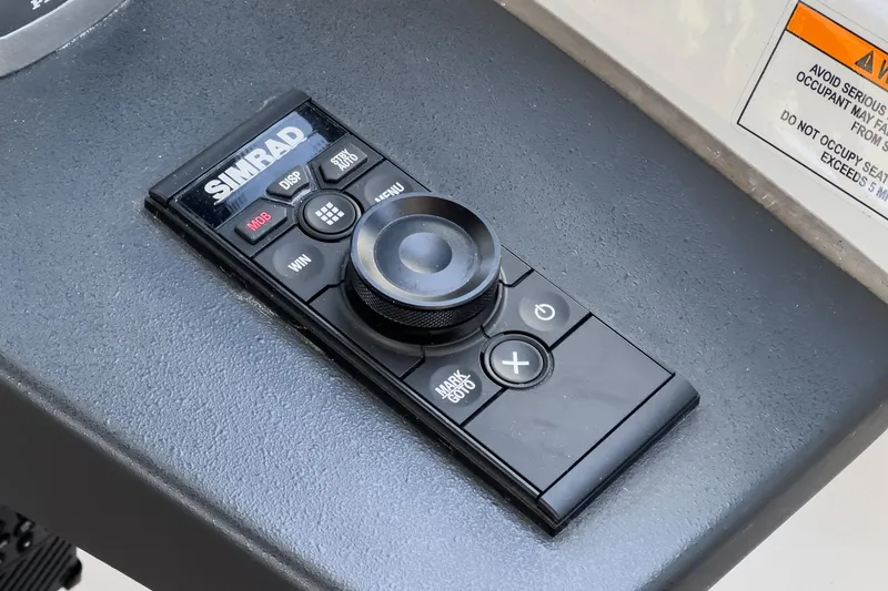 Slide: The Image of Simrad control panel on Bavaria SR36 yacht, 2023 model, featuring navigation buttons and joystick. - 38