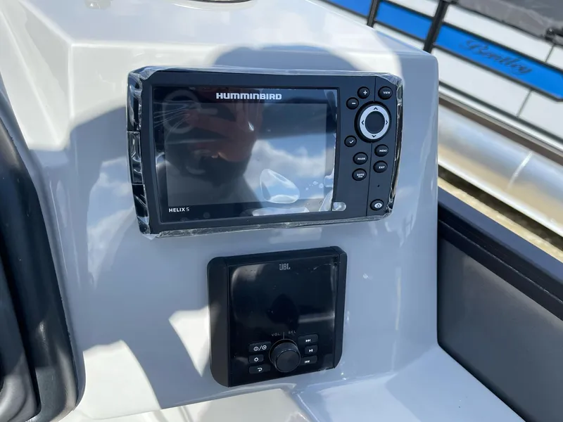 Slide: The Image of 2025 Bentley Pontoons Legacy 243 QSB dashboard with Humminbird Helix and JBL controls. - 13