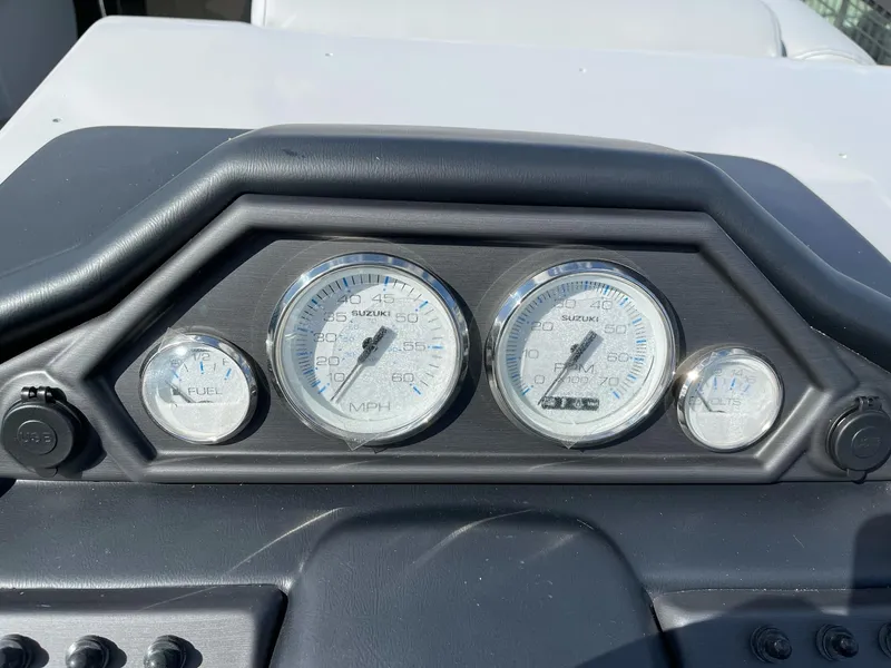 Slide: The Image of Dashboard of 2025 Bentley Pontoons Legacy 243 QSB, featuring speedometer and fuel gauges. - 14