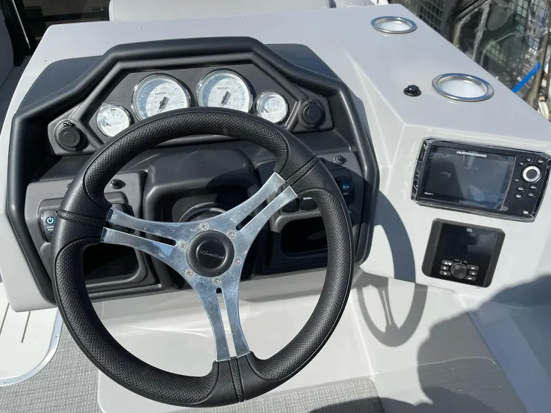 Slide: The Image of 2025 Bentley Pontoons Legacy 243 QSB dashboard with steering wheel and gauges. - 17