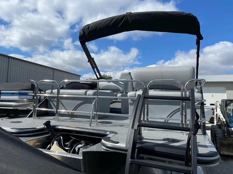 Slide: The Image of 2025 Bentley Pontoons Legacy 243 QSB Dual Captain, full tube, docked under blue sky. - 19