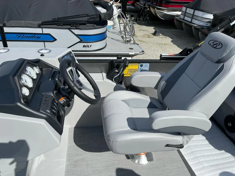 Slide: The Image of 2025 Bentley Pontoons Legacy 243 QSB Dual Captain seat and dashboard, showcasing luxury design. - 22