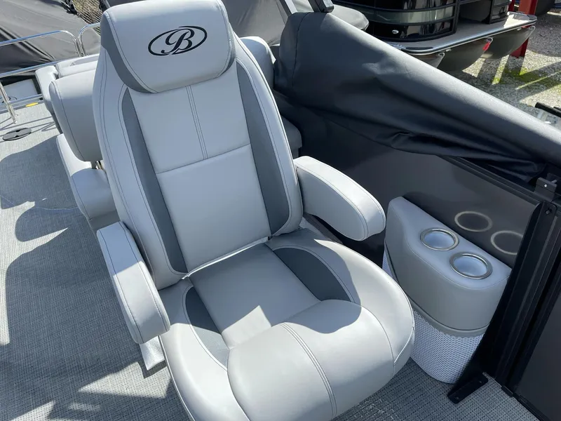 Slide: The Image of Luxurious captain's chair on 2025 Bentley Pontoons Legacy 243 QSB, featuring sleek design and cup holders. - 23