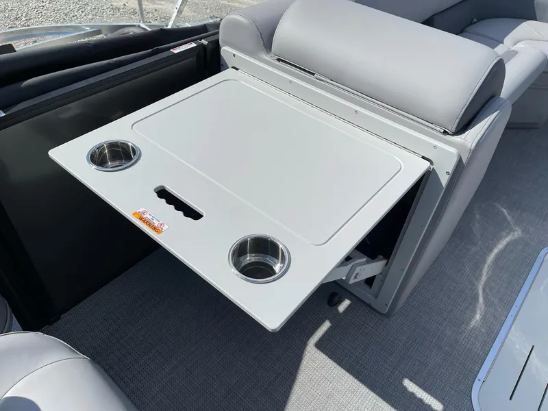 Slide: The Image of 2025 Bentley Pontoons Legacy 243 QSB interior with foldable table and cup holders. - 24
