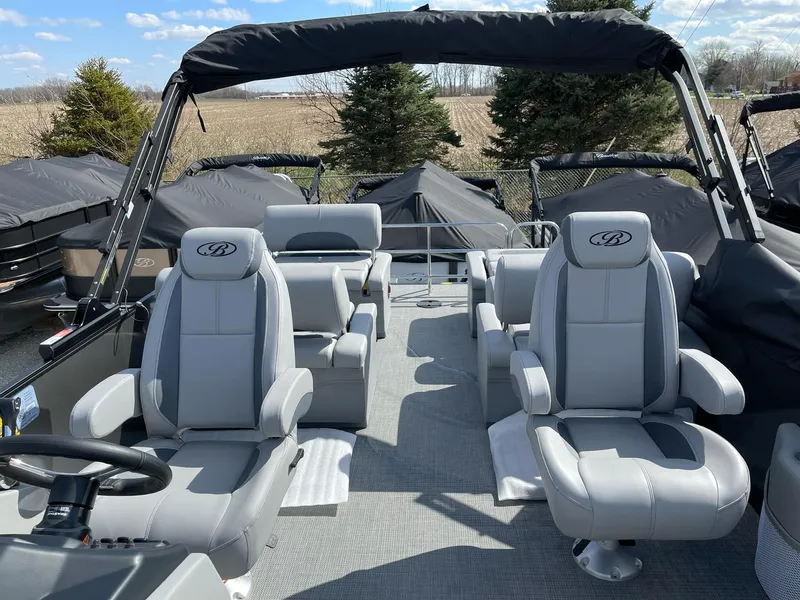 Slide: The Image of 2025 Bentley Pontoons Legacy 243 QSB Dual Captain, luxury seating, open deck, outdoor setting. - 26