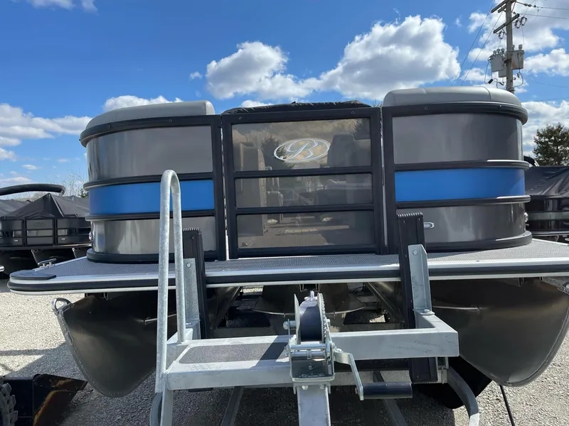 Slide: The Image of 2025 Bentley Pontoons Legacy 243 QSB Dual Captain Full Tube on trailer, under blue sky. - 3