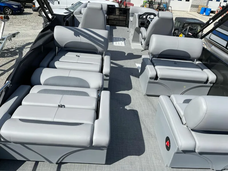 Slide: The Image of 2025 Bentley Pontoons Legacy 243 QSB interior with dual captain seats and gray upholstery. - 5