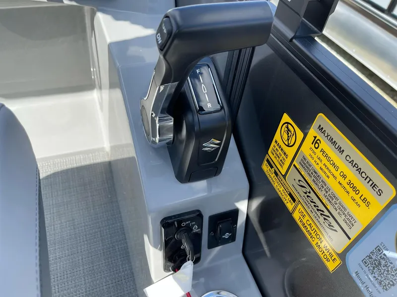 Slide: The Image of 2025 Bentley Pontoons Legacy 243 QSB control panel with throttle and capacity label. - 7