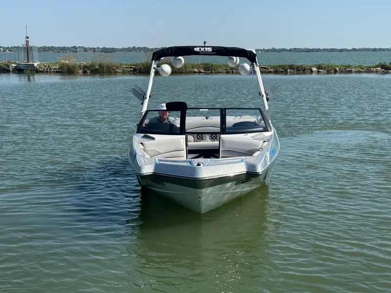 Slide: The Image of 2015 Axis A22 boat on calm lake water, front view. - 2