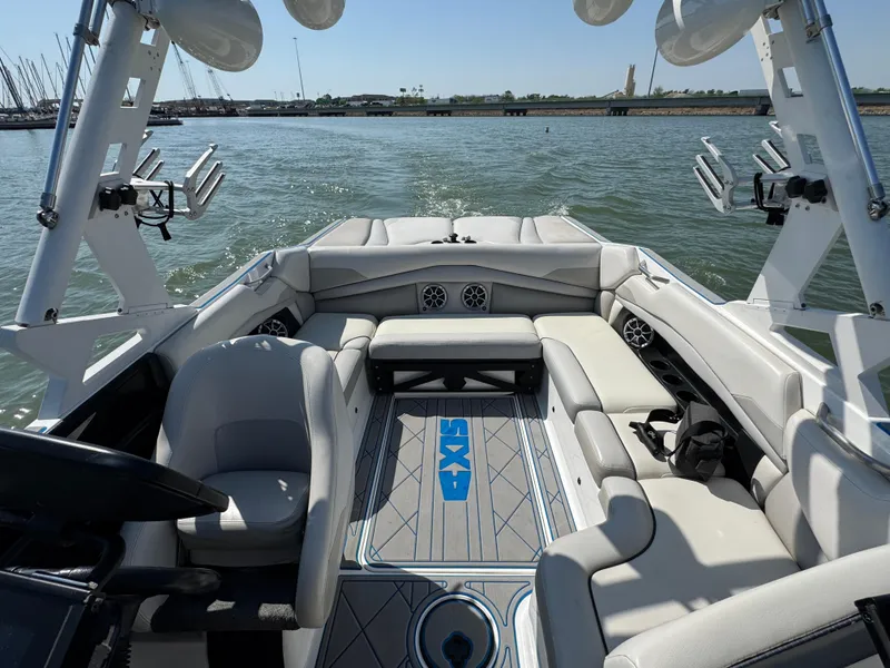 Slide: The Image of 2015 Axis A22 boat interior with gray seating and water view. - 9