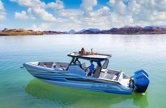 Slide: The Image of 2025 AMP 333 boat on serene lake with clear skies and distant mountains. - 0