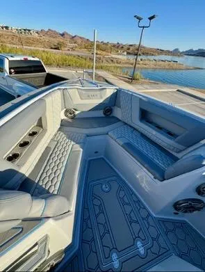 Slide: The Image of Luxurious AMP 333 boat interior, 2025 model, featuring plush seating and modern design by a serene lake. - 5
