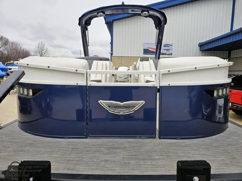 Slide: The Image of 2021 Bennington RX 25 Quad Bench pontoon boat, blue exterior, docked at marina. - 14