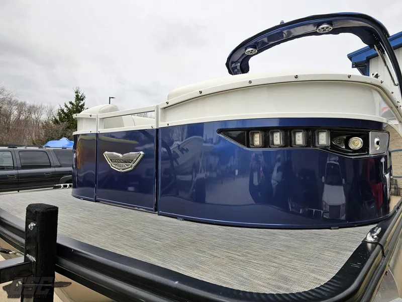 Slide: The Image of 2021 Bennington RX 25 Quad Bench pontoon boat with sleek blue exterior. - 17
