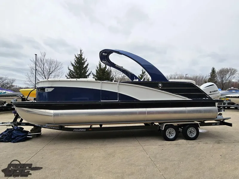 Slide: The Image of 2021 Bennington RX 25 Quad Bench pontoon boat on trailer, side view. - 19