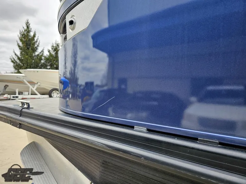 Slide: The Image of 2021 Bennington RX 25 Quad Bench boat, blue exterior, close-up view. - 23